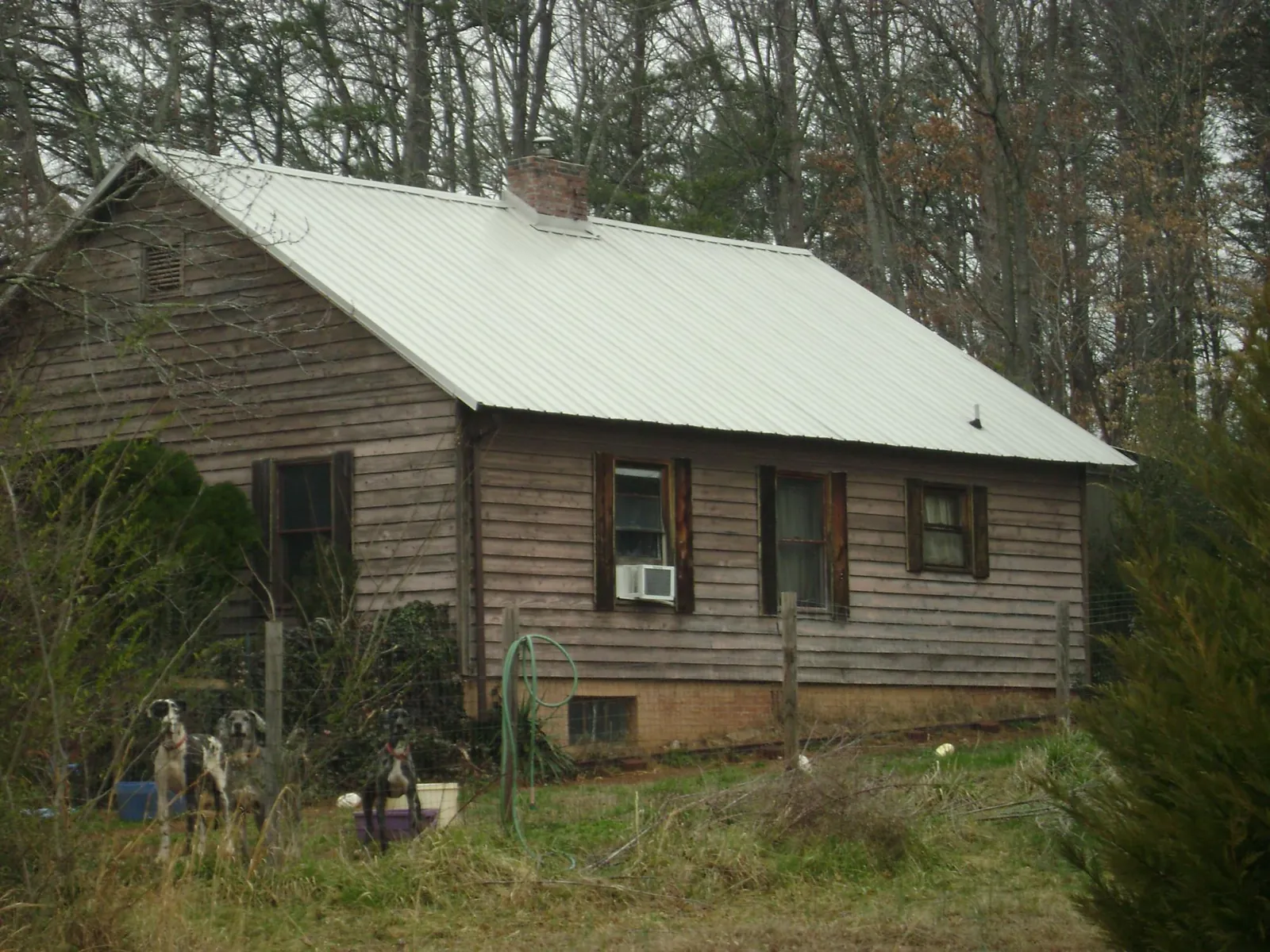 White metal roof on an old wood sided farmhouse, from a Metal Roof Installation job in Plum Branch